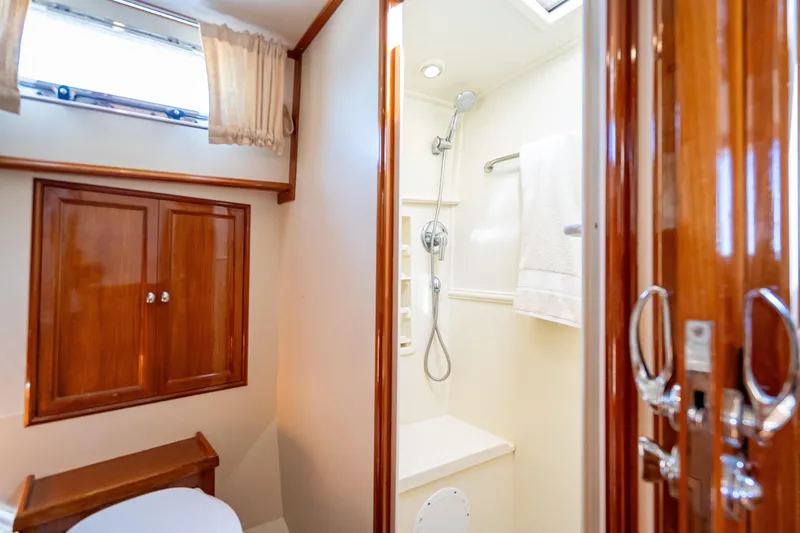 Slide: The Image of Luxurious bathroom in 2008 Grand Banks 47 Eastbay FB yacht with wooden cabinetry and shower. - 54