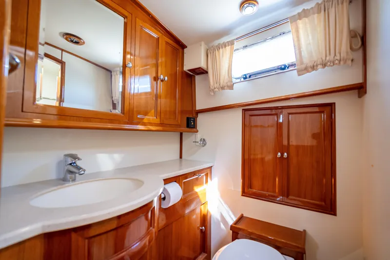 Slide: The Image of Luxurious 2008 Grand Banks 47 Eastbay FB yacht bathroom with wooden cabinetry and modern fixtures. - 55