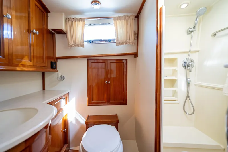 Slide: The Image of Luxurious bathroom in 2008 Grand Banks 47 Eastbay FB yacht with wood cabinetry and shower. - 56
