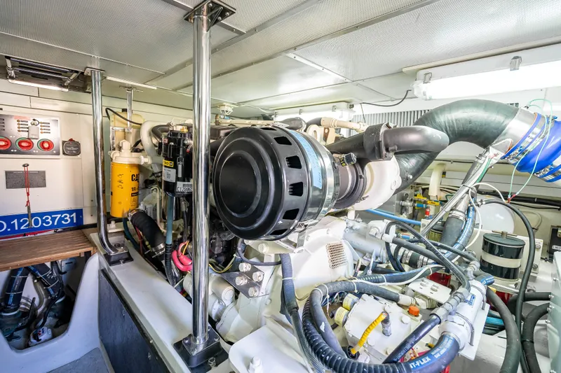 Slide: The Image of Engine room of 2008 Grand Banks 47 Eastbay FB, showcasing mechanical components and wiring. - 59