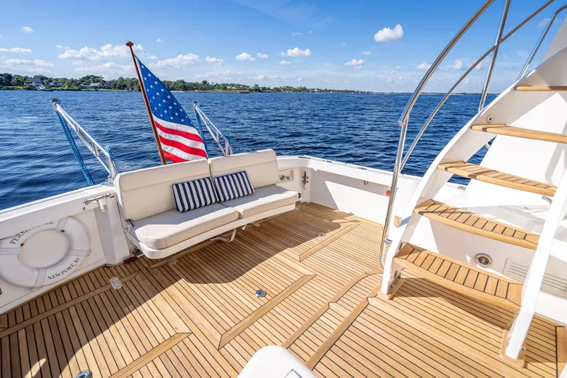 Slide: The Image of 2008 Grand Banks 47 Eastbay FB yacht deck with seating, American flag, and ocean view. - 9