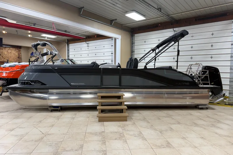 The Image of 2026 Harris Grand Mariner 250 pontoon boat in showroom, sleek design, modern features. - 1