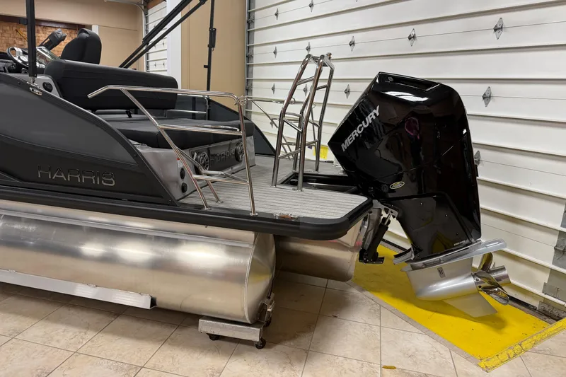 Slide: The Image of 2026 Harris Grand Mariner 250 pontoon boat with Mercury outboard motor in garage. - 16