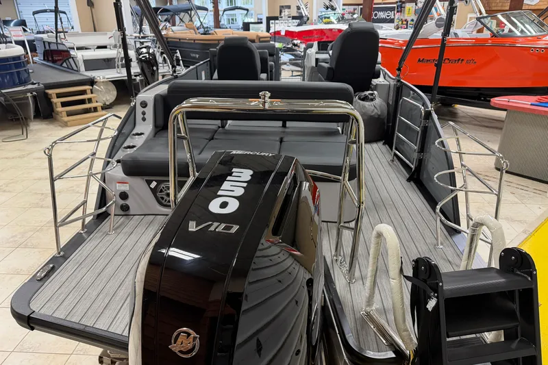 Slide: The Image of 2026 Harris Grand Mariner 250 boat with Mercury 350 V10 engine in showroom. - 17