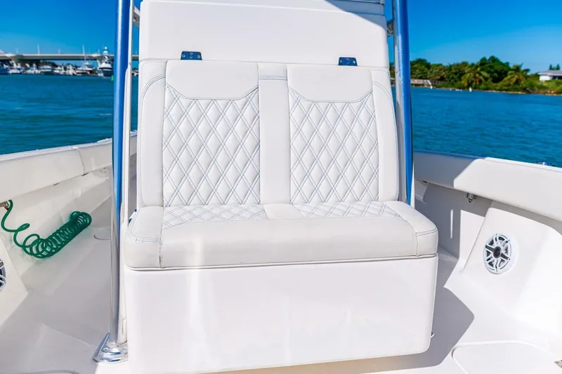Slide: The Image of Luxurious seating on 2022 Conch 27 boat with diamond-stitched upholstery, ocean backdrop. - 20
