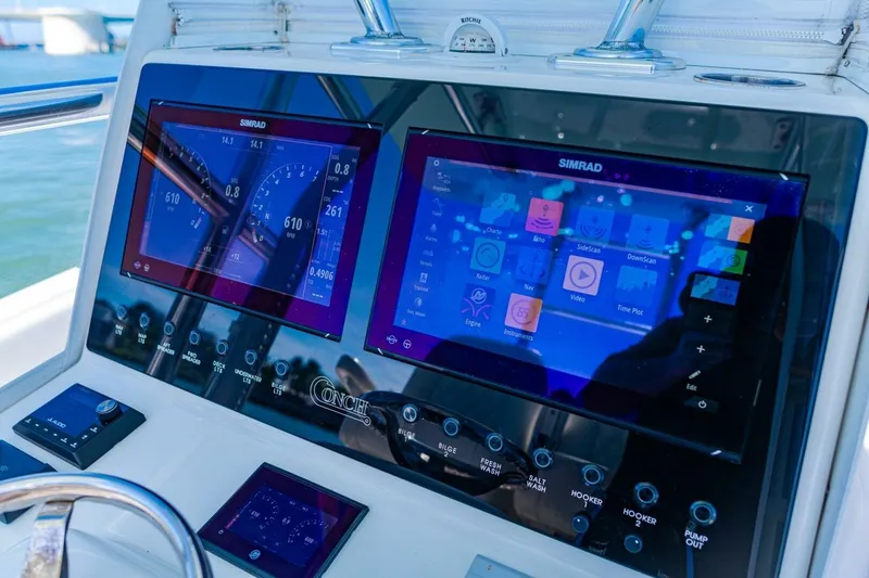 Slide: The Image of Dashboard of 2022 Conch 27 boat with Simrad navigation displays. - 25