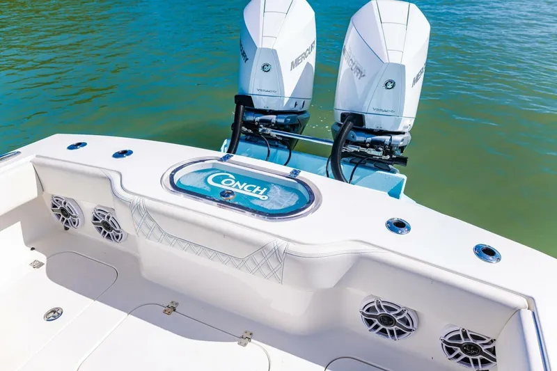 Slide: The Image of 2022 Conch 27 boat with dual Mercury engines on calm water. - 30