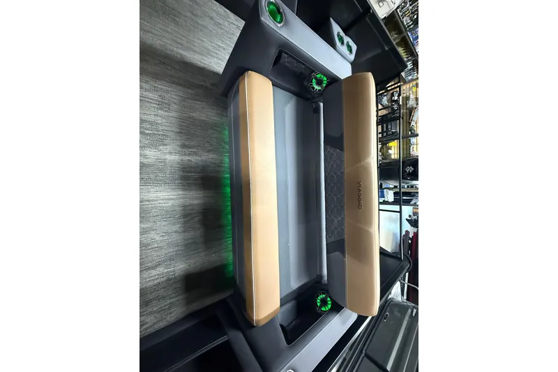 Slide: The Image of 2026 Viaggio Diamante 24S boat interior with tan seating and green cup holders. - 10