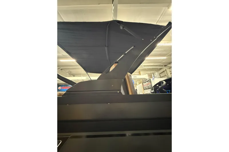 Slide: The Image of 2026 Viaggio Diamante 24S boat with canopy, showcased indoors. - 24