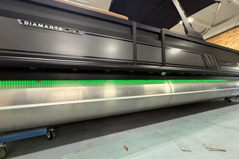 Slide: The Image of 2026 Viaggio Diamante 24S pontoon boat with sleek design and green LED lighting. - 3