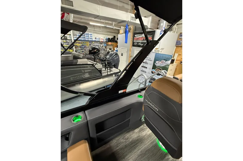 Slide: The Image of Interior view of 2026 Viaggio Diamante 24S boat in showroom with modern seating and controls. - 9