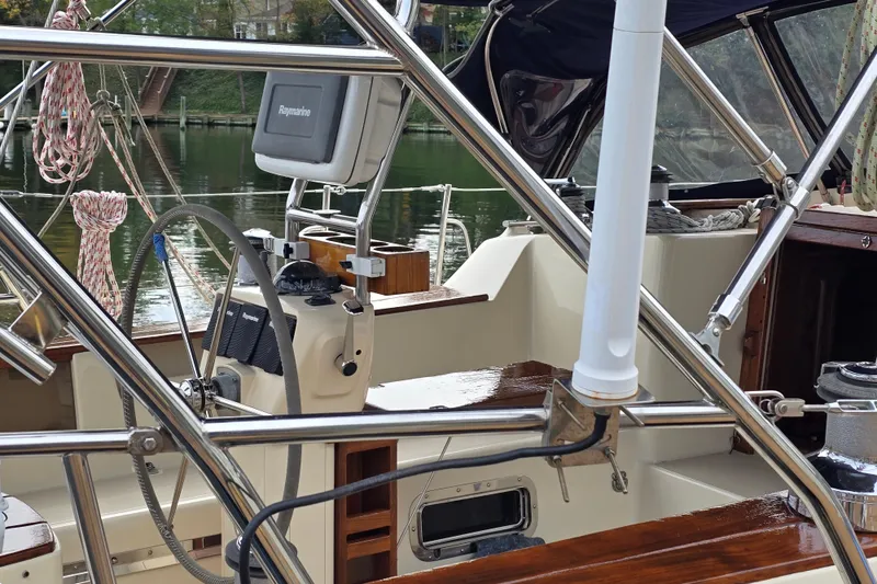 Slide: The Image of Cockpit of 2001 Island Packet 420 sailboat with steering wheel and navigation equipment. - 15
