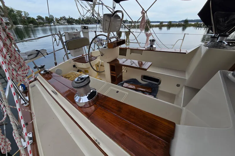 Slide: The Image of 2001 Island Packet 420 sailboat cockpit with polished wood and nautical equipment. - 17