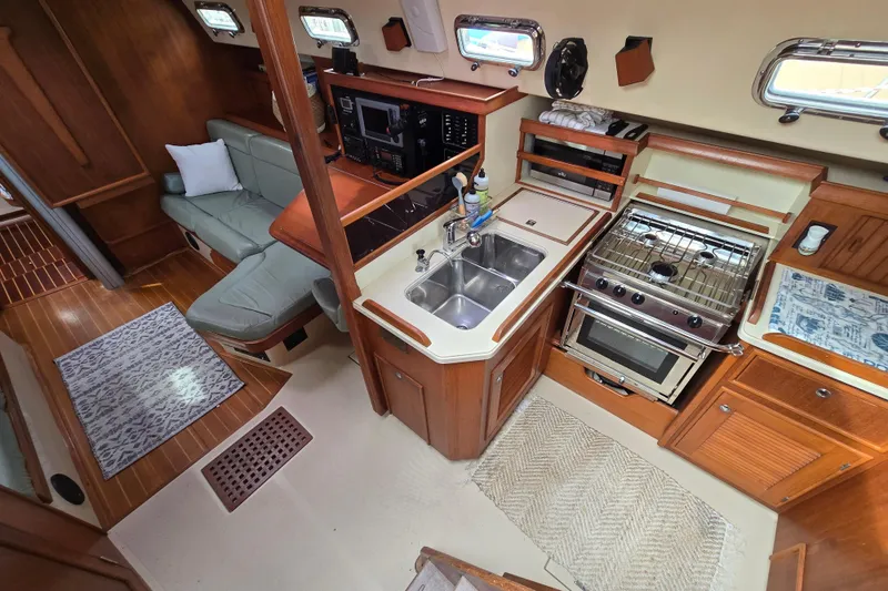 Slide: The Image of Interior of 2001 Island Packet 420 yacht with kitchen and seating area. - 30