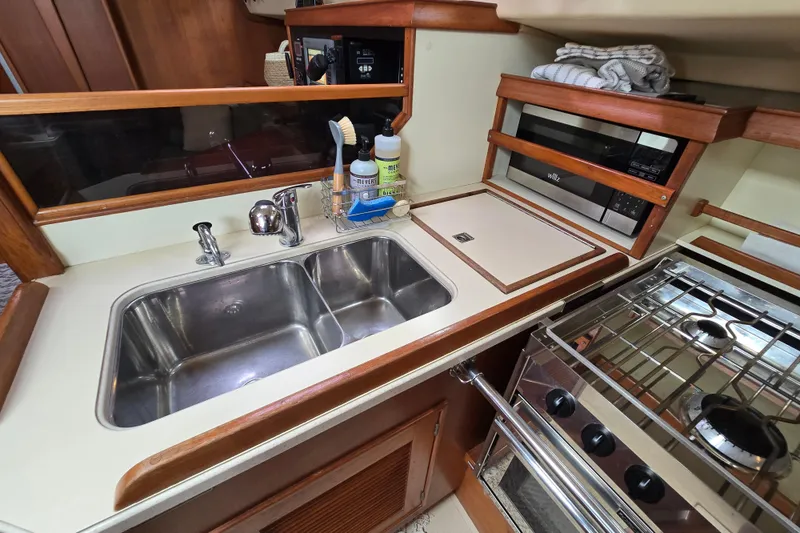 Slide: The Image of Island Packet 420 yacht kitchen with sink, stove, and microwave, 2001 model. - 42