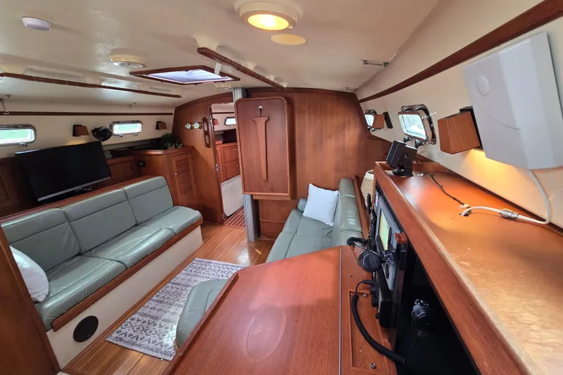 Slide: The Image of Interior of 2001 Island Packet 420 yacht with cozy seating and navigation equipment. - 44