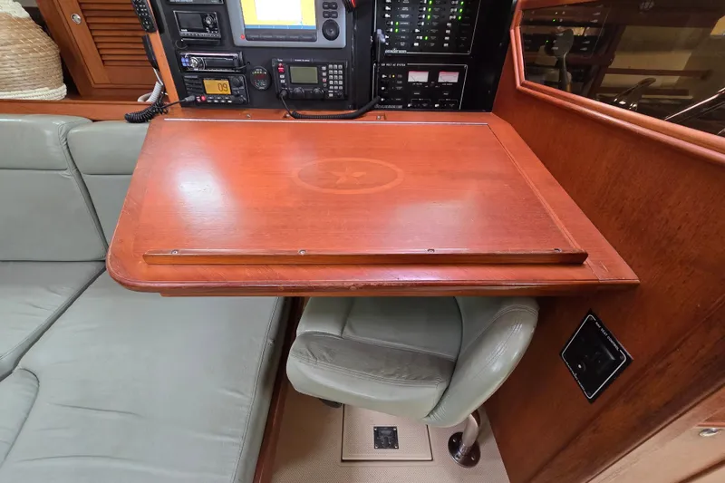 Slide: The Image of Navigation station with wooden table and electronics on a 2001 Island Packet 420 yacht. - 47