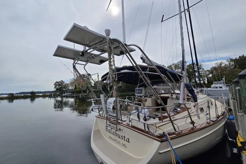 Slide: The Image of Island Packet 420 sailboat docked, featuring solar panels and nautical equipment, Annapolis, Maryland. - 5