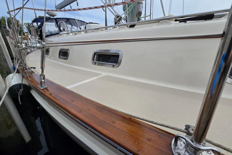 Slide: The Image of 2001 Island Packet 420 sailboat deck with polished wood and stainless steel fittings. - 7