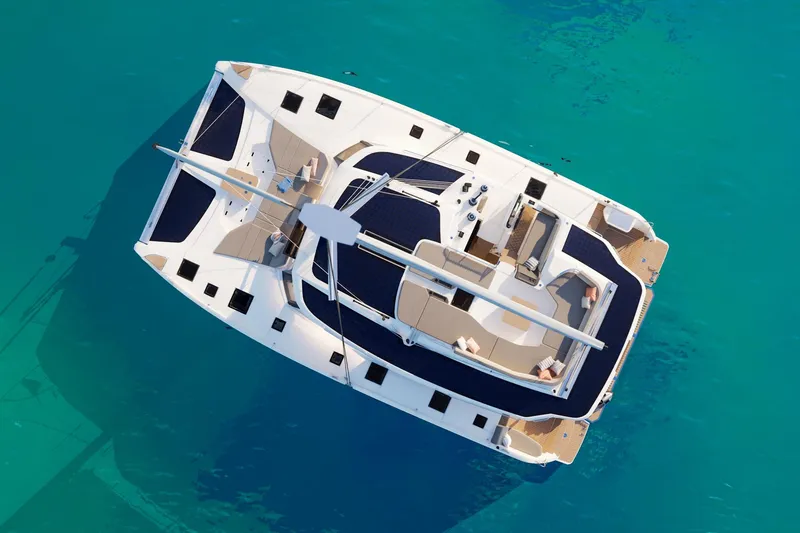 Slide: The Image of Aerial view of 2026 Fountaine Pajot 48 catamaran on turquoise water. - 34