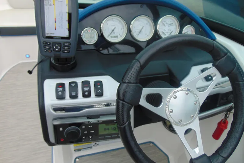 Slide: The Image of 2016 Regal 2000 ESX Bowrider dashboard with steering wheel and navigation controls. - 12