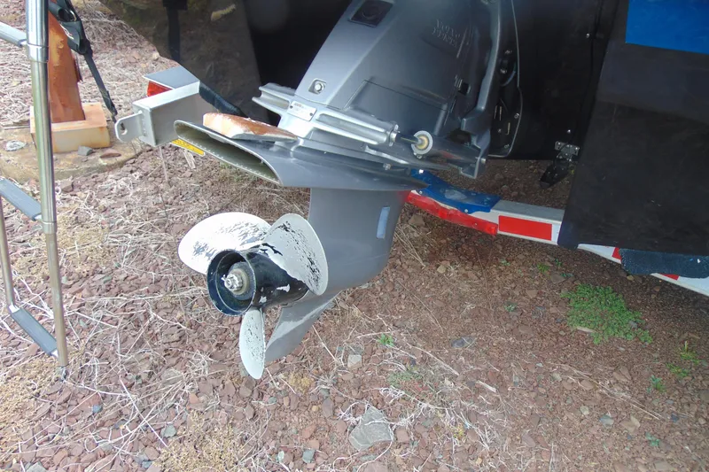 Slide: The Image of 2016 Regal 2000 ESX Bowrider boat propeller on rocky ground. - 4