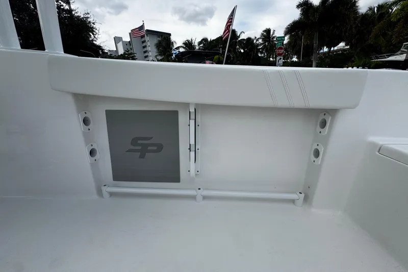 Slide: The Image of 2026 Sea Pro 240 Dual Console boat interior with storage compartment and rod holders. - 20