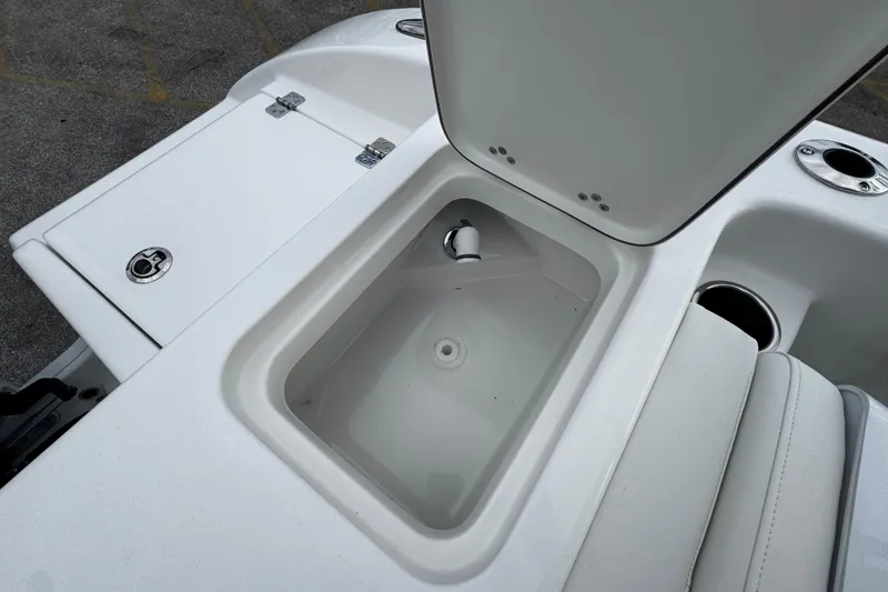 Slide: The Image of Open storage compartment on 2026 Sea Pro 240 Dual Console boat deck. - 27