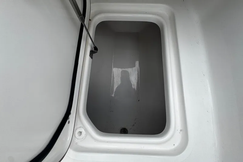 Slide: The Image of Storage compartment of 2026 Sea Pro 240 Dual Console boat, open and empty. - 29
