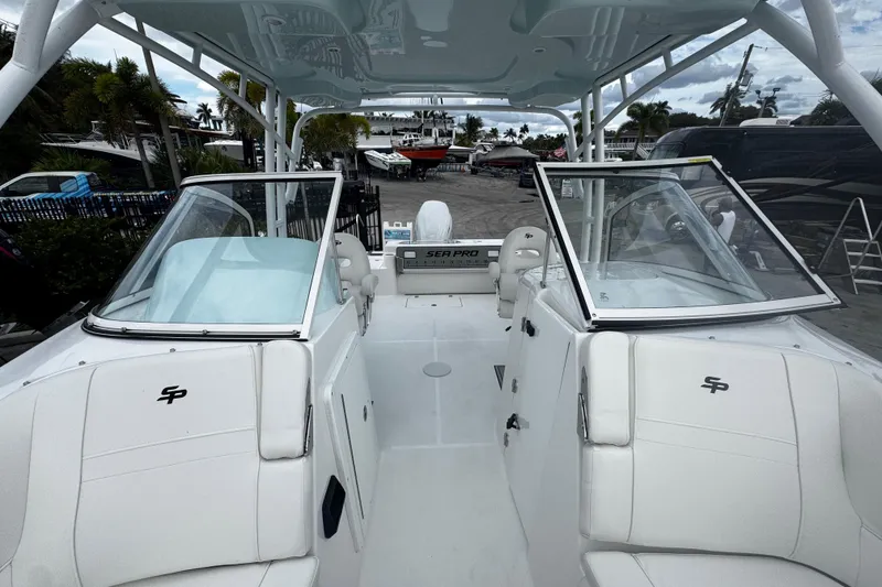 Slide: The Image of 2026 Sea Pro 240 Dual Console boat with white interior and open deck view. - 6