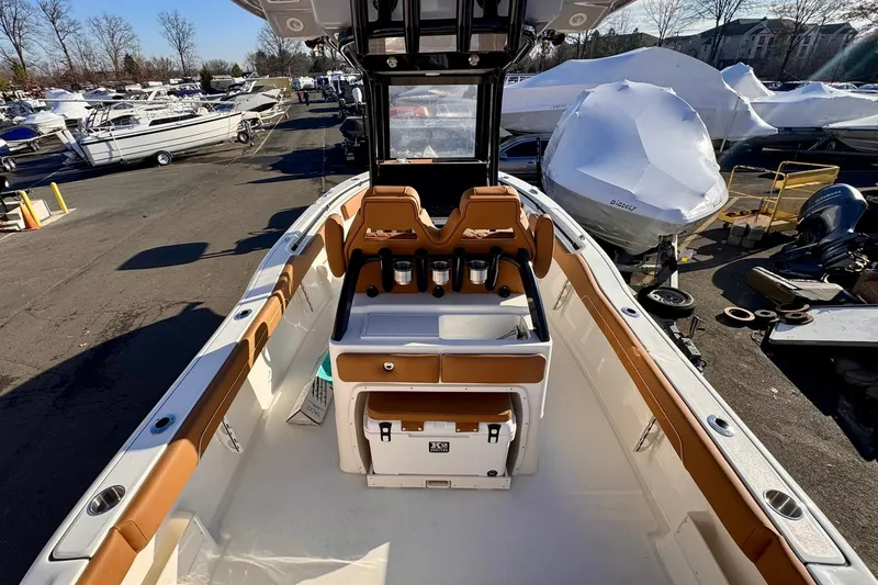 Slide: The Image of 2026 Key West 239 FSR boat interior with tan seating and storage compartments. - 16