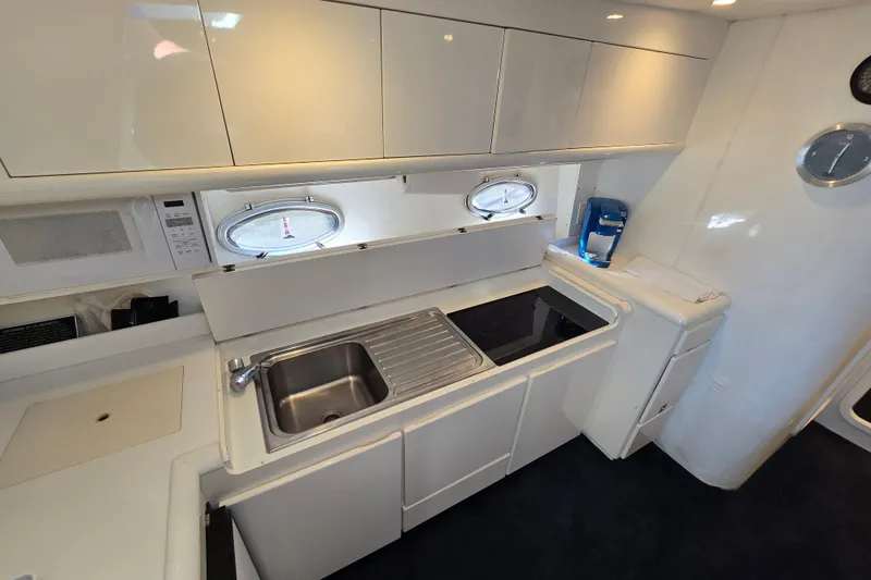 Slide: The Image of Modern kitchen interior in a 1993 Giorgi 46 yacht, featuring sleek cabinetry and appliances. - 101