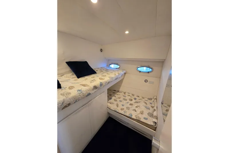 Slide: The Image of Cozy cabin with bunk beds in 1993 Giorgi 46 yacht, featuring nautical-themed bedding. - 115