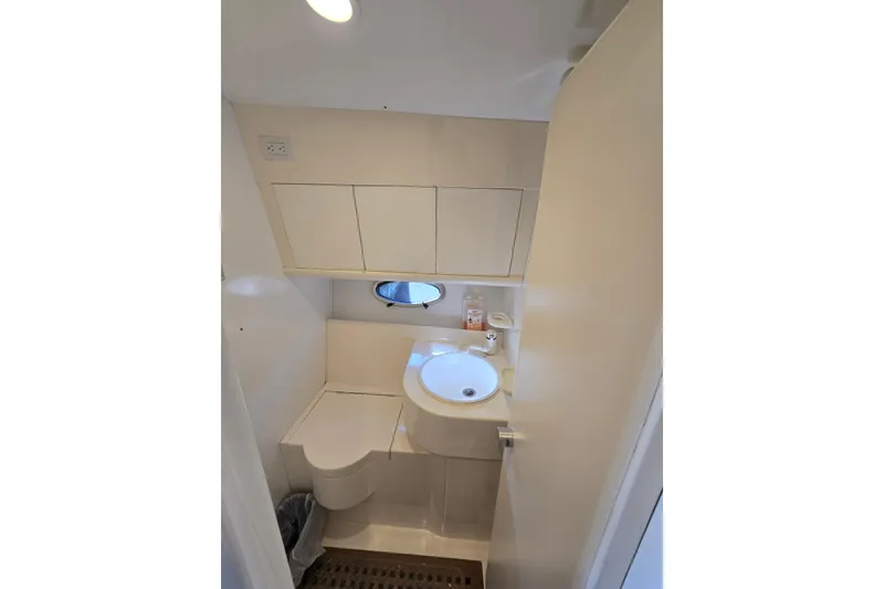 Slide: The Image of Compact bathroom in a 1993 Giorgi 46 boat, featuring a sink and storage cabinets. - 116