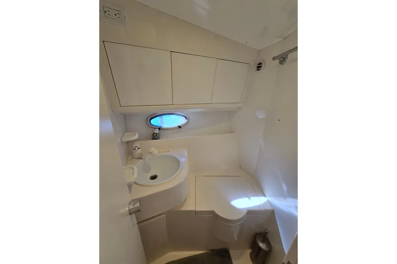Slide: The Image of Compact bathroom in 1993 Giorgi 46 yacht with sink, toilet, and porthole window. - 117