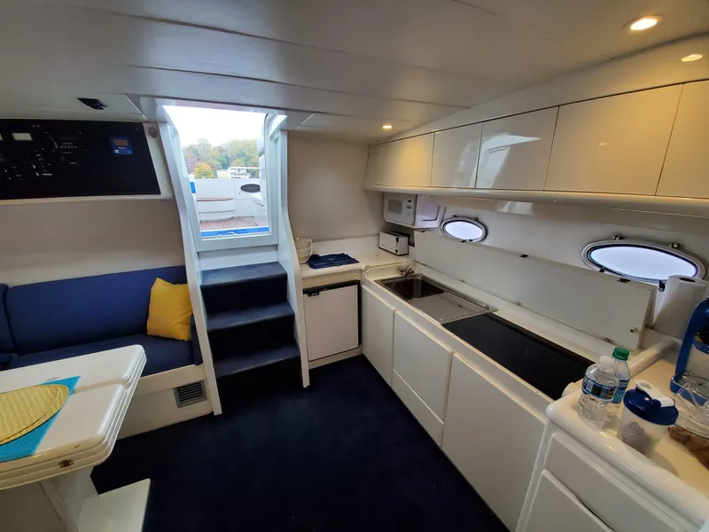 Slide: The Image of Interior of a 1993 Giorgi 46 yacht with modern kitchen and seating area. - 12