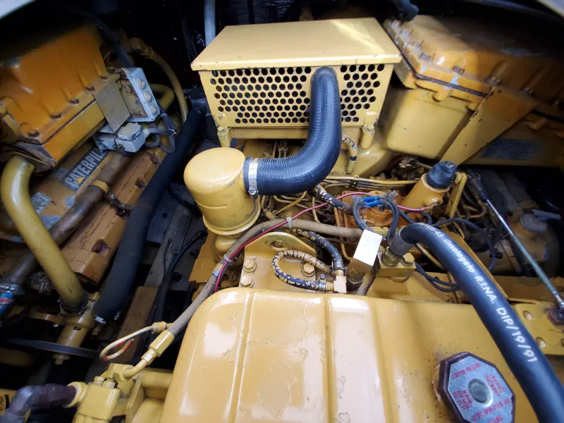 Slide: The Image of Engine compartment of a 1993 Giorgi 46, featuring yellow components and black hoses. - 33