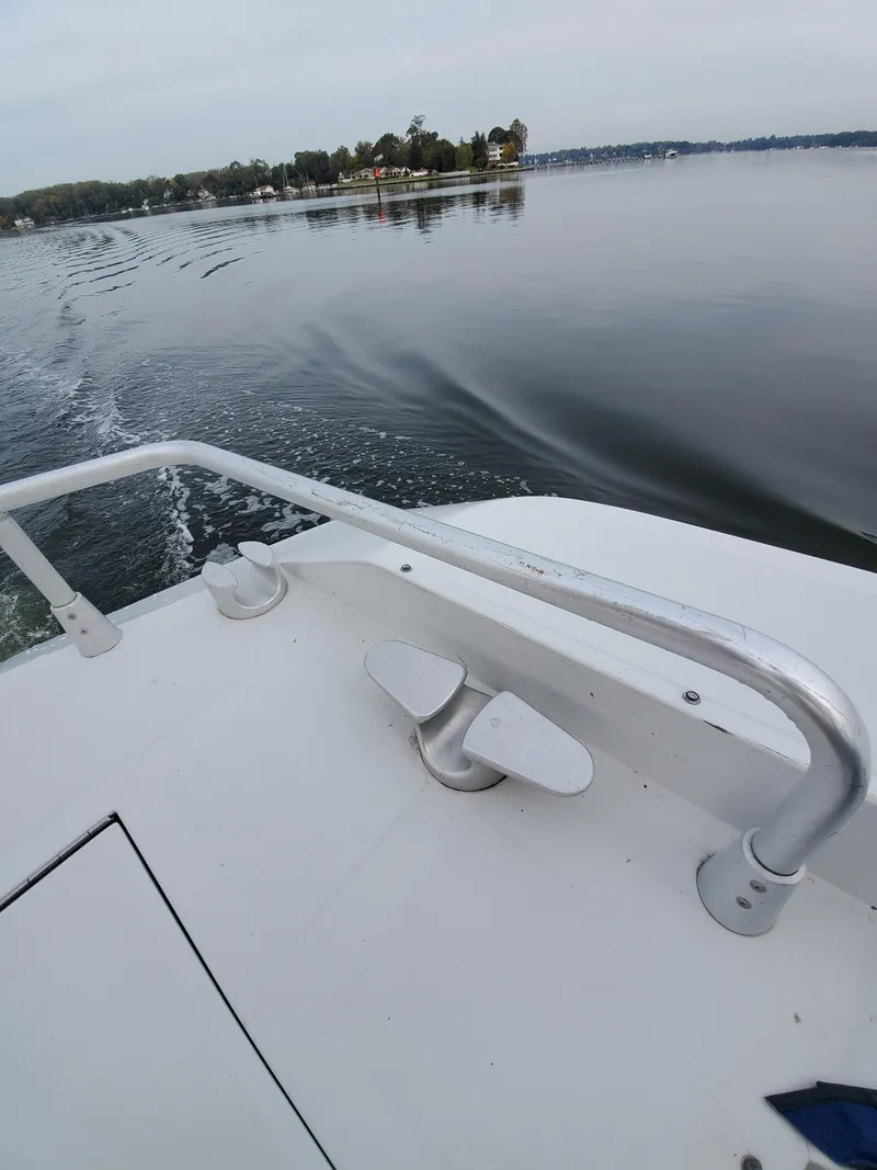Slide: The Image of 1993 Giorgi 46 boat cruising on a calm lake with distant shoreline view. - 46
