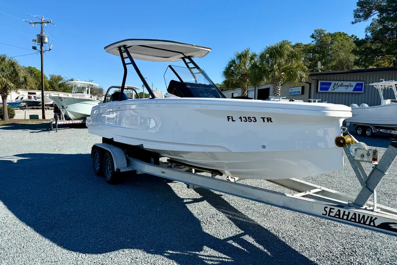 Slide: The Image of 2022 Axopar 22 boat on trailer in sunny outdoor setting. - 11