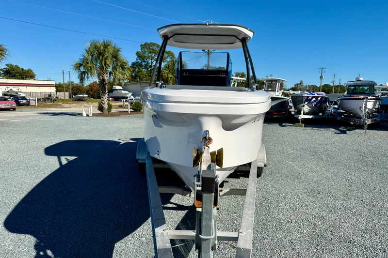 Slide: The Image of 2022 Axopar 22 boat on trailer, displayed outdoors under clear blue sky. - 13