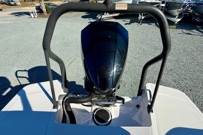 Slide: The Image of 2022 Axopar 22 boat engine and deck, parked outdoors. - 15