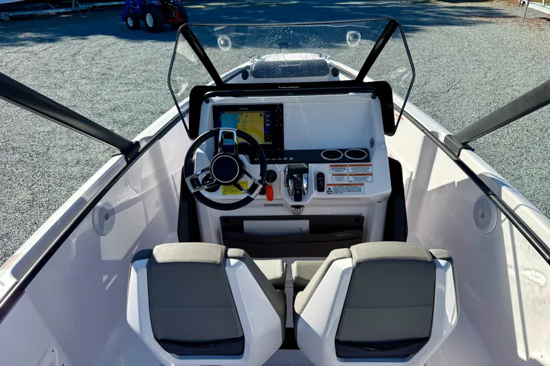 Slide: The Image of Interior view of 2022 Axopar 22 boat cockpit with steering wheel and controls. - 21