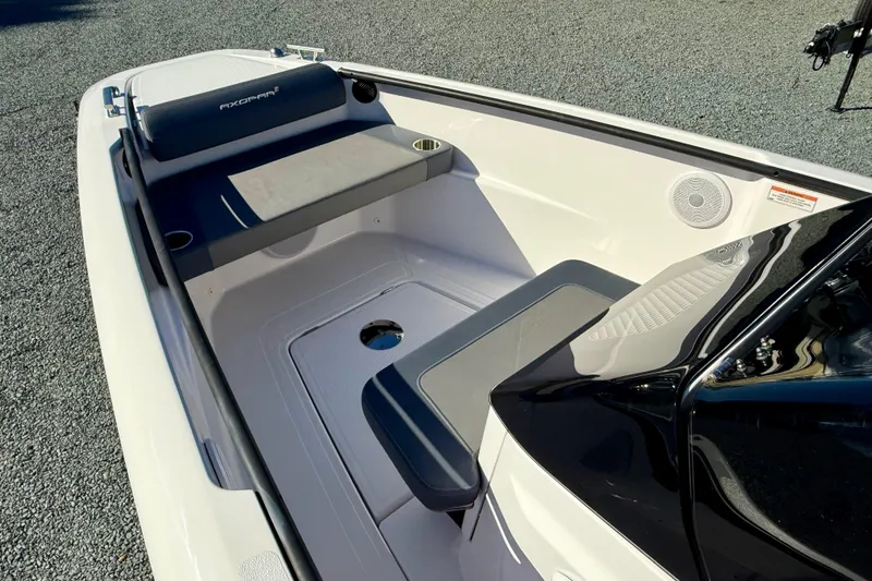 Slide: The Image of 2022 Axopar 22 boat interior with seating and cup holders, showcasing modern design. - 28
