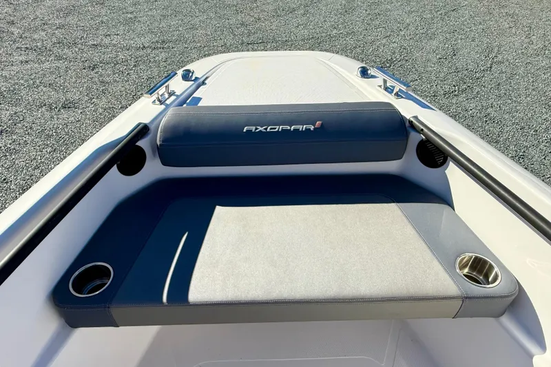 Slide: The Image of 2022 Axopar 22 boat interior with cushioned seating and cup holders. - 29