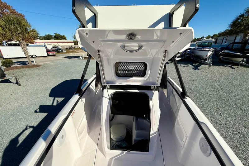 Slide: The Image of 2022 Axopar 22 boat with open storage compartment, outdoor setting. - 31