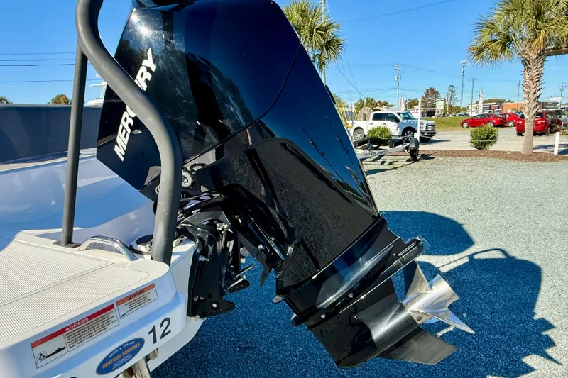 Slide: The Image of 2022 Axopar 22 boat with Mercury outboard motor in a sunny outdoor setting. - 4