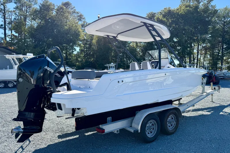 Slide: The Image of 2022 Axopar 22 boat on trailer with Mercury outboard motor, parked outdoors. - 8