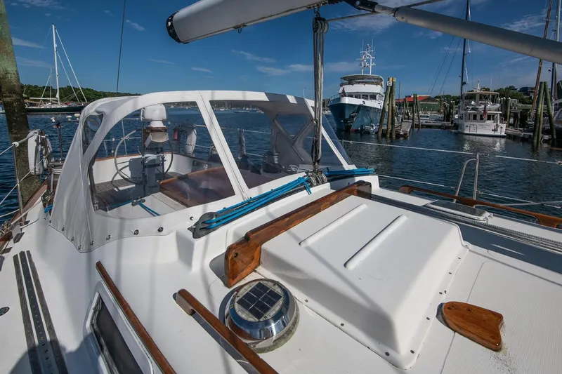 Slide: The Image of 1984 Hank Hinckley OC42 sailboat docked in a marina under clear blue skies. - 17
