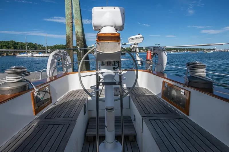 Slide: The Image of Cockpit of 1984 Hank Hinckley OC42 sailboat with wooden deck, docked in a marina. - 21