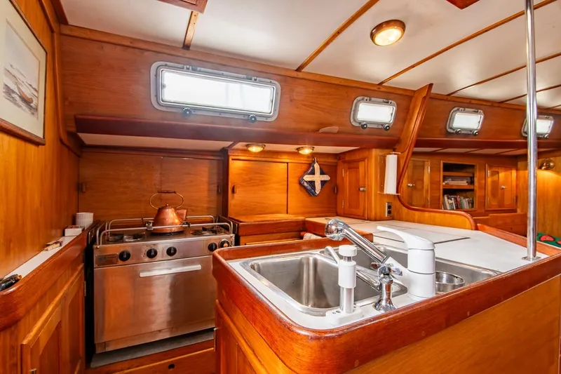 Slide: The Image of Cozy 1984 Hank Hinckley OC42 yacht kitchen with wood finish and stainless steel appliances. - 26